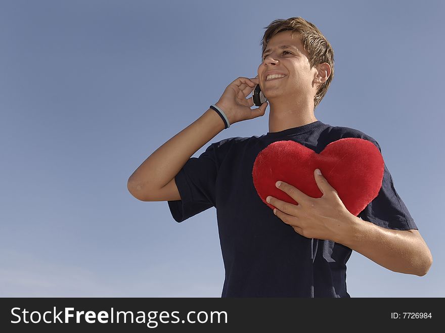 Boy in love holding a big red heart. Boy in love holding a big red heart