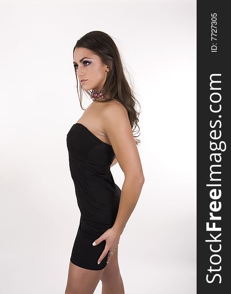 Pretty brunette model posing wearing a black dress. Pretty brunette model posing wearing a black dress