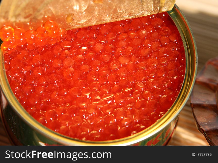 Open canning iron bank of red caviar.