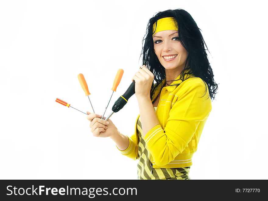 Beautiful cheerful brunette woman holding four screwdrivers in her hands. Beautiful cheerful brunette woman holding four screwdrivers in her hands