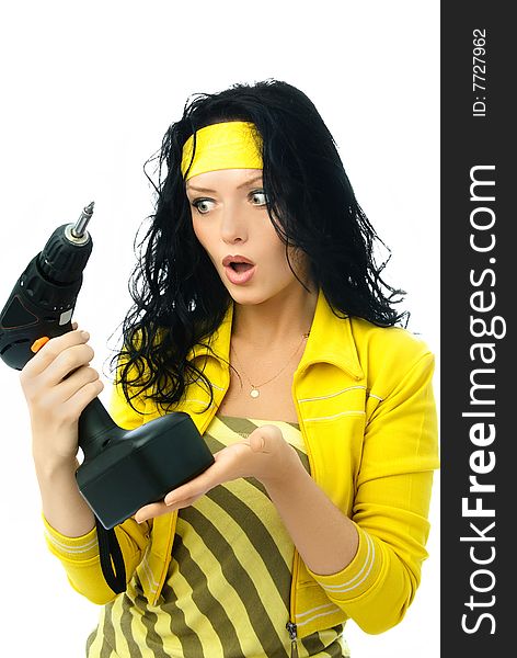 Beautiful young surprised woman holding a drill isolated against white background. Beautiful young surprised woman holding a drill isolated against white background