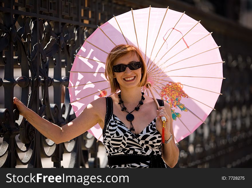 Lovely smiling woman with pink sunshade in Rome town, Italy. Lovely smiling woman with pink sunshade in Rome town, Italy