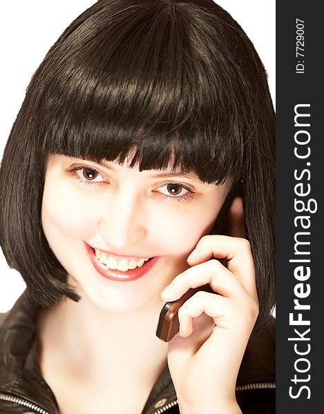 Young beautiful brunette talking to mobile phone with smile, isolated