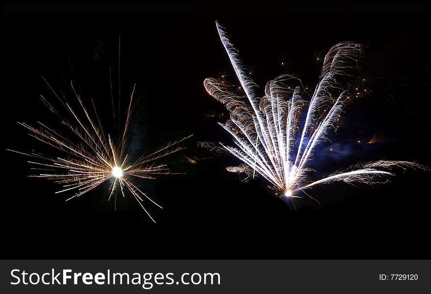 Two beautiful flashes of fireworks in the night sky. Two beautiful flashes of fireworks in the night sky.