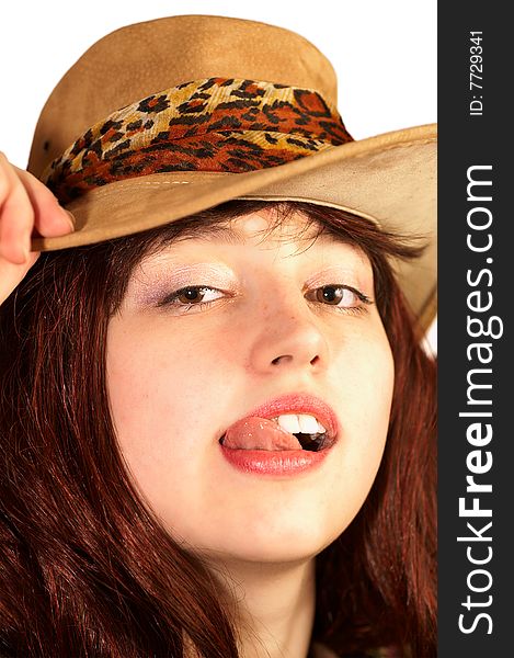 Young woman in hat shows tongue, isolated