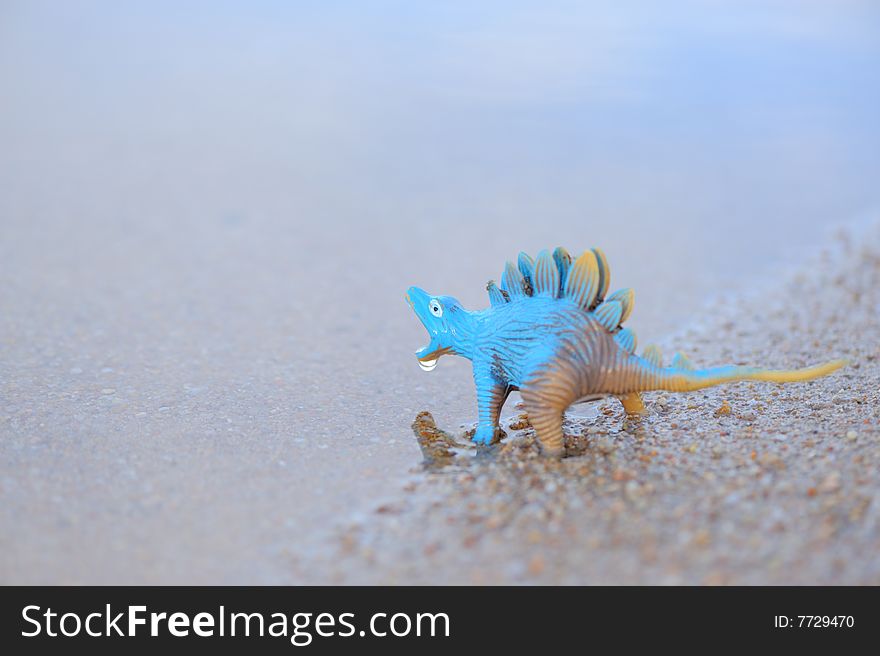 Scene of a blue plastic dinosaur at sea