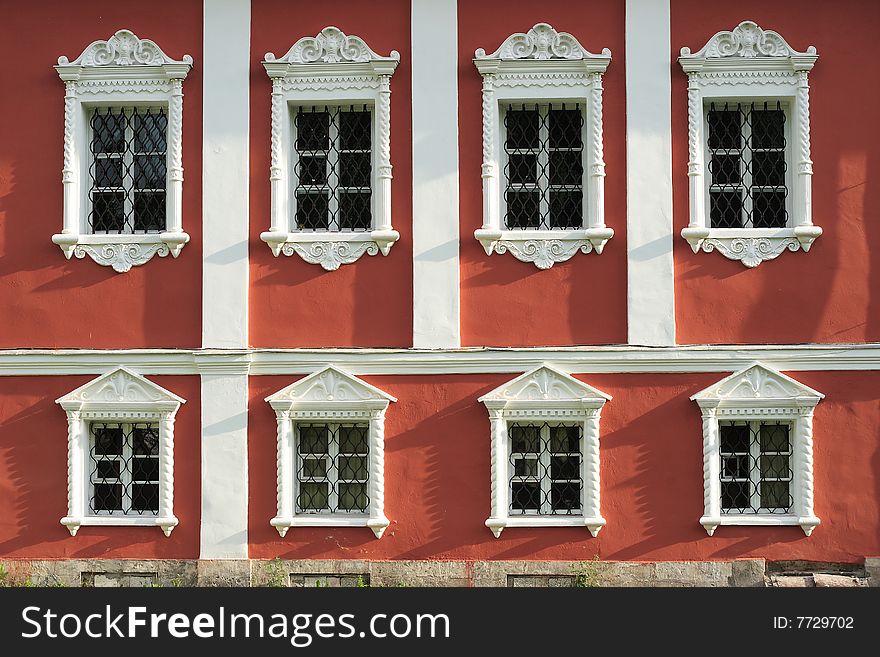 Nikolo-Ugreshsky monastery. White windows on the red wall. Nikolo-Ugreshsky monastery. White windows on the red wall.