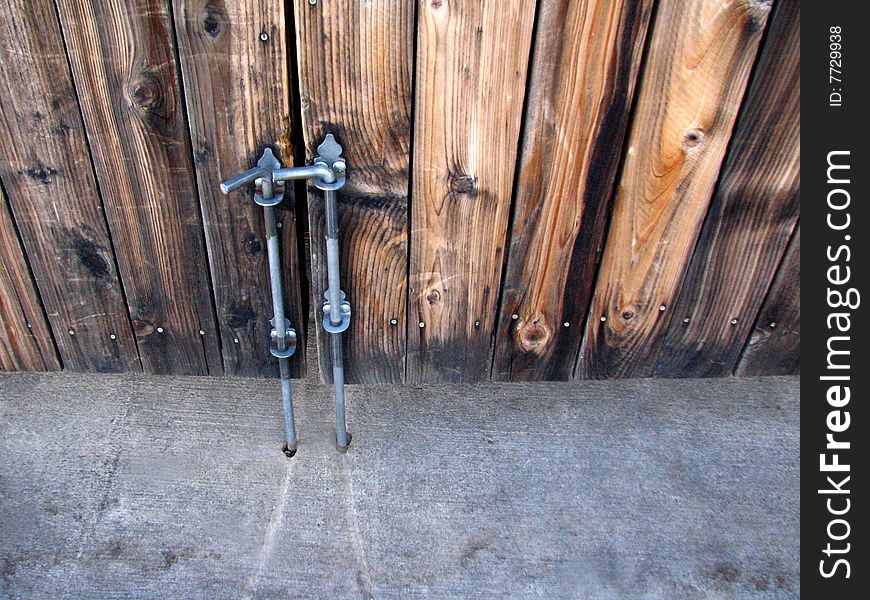 Looking down at a wooden gate with a metal closure. Looking down at a wooden gate with a metal closure.