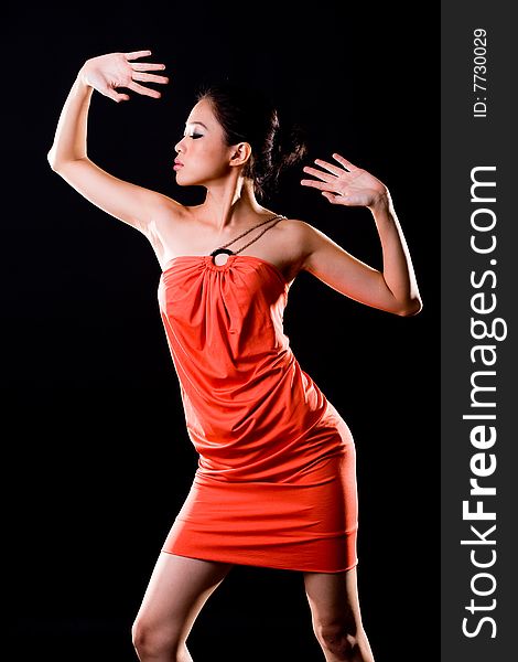 Young woman in a dance pose side profile. Young woman in a dance pose side profile