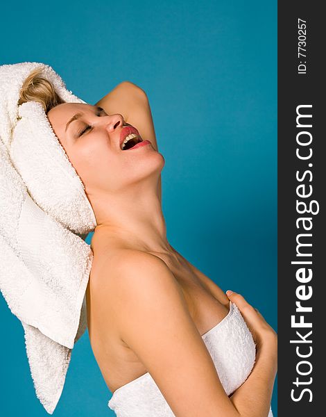 Expressive portrait of lovely woman in white towel over background