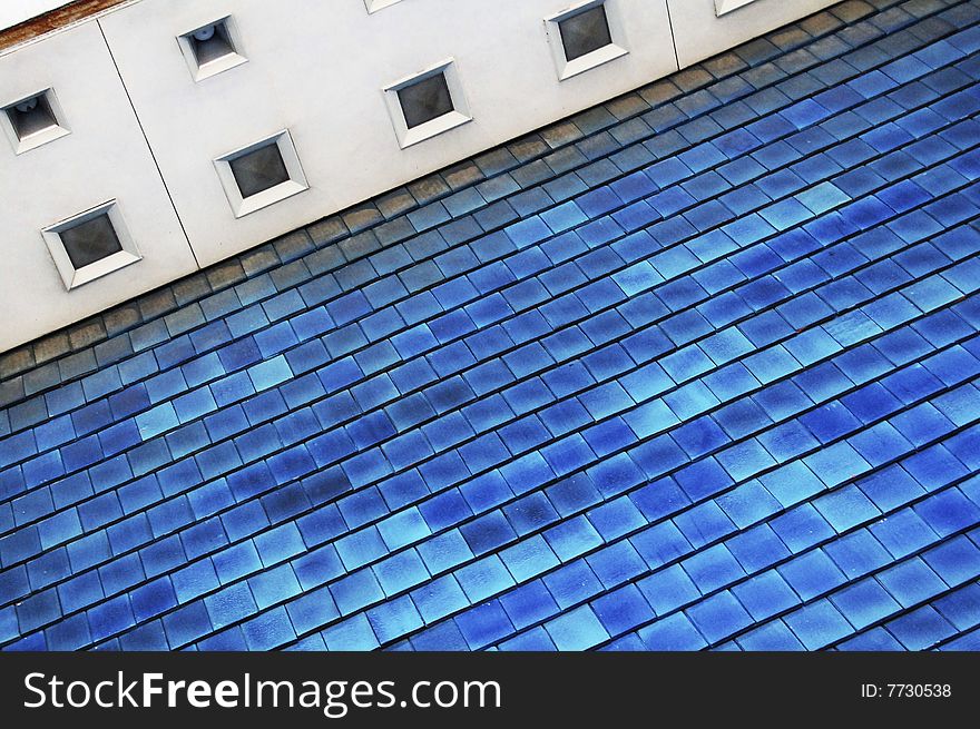 Large portion of a roof with blue shingles. Large portion of a roof with blue shingles