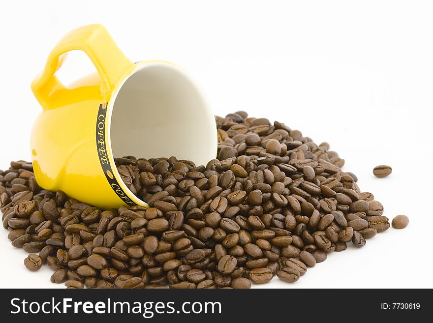 It ' s a stack of coffee beans with yellow cup. It ' s a stack of coffee beans with yellow cup