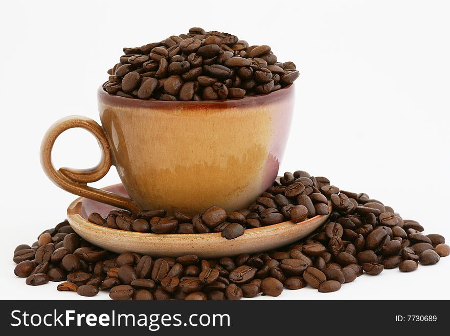 This ' a a stack of coffee beans with cup and plate. This ' a a stack of coffee beans with cup and plate