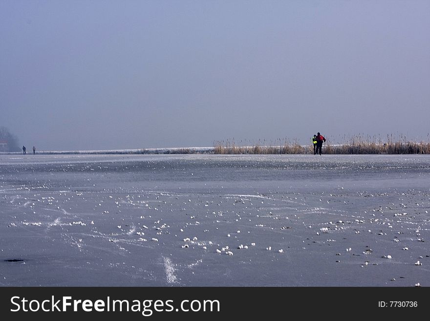 A winter picture of people skating. A winter picture of people skating