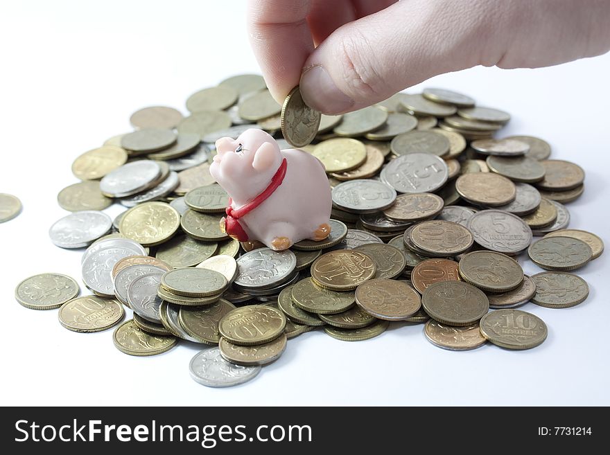 Businessman loading a piggy bank.coins