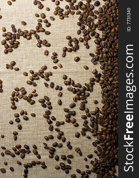 Coffee beans spilled over a natural background. Coffee beans spilled over a natural background.