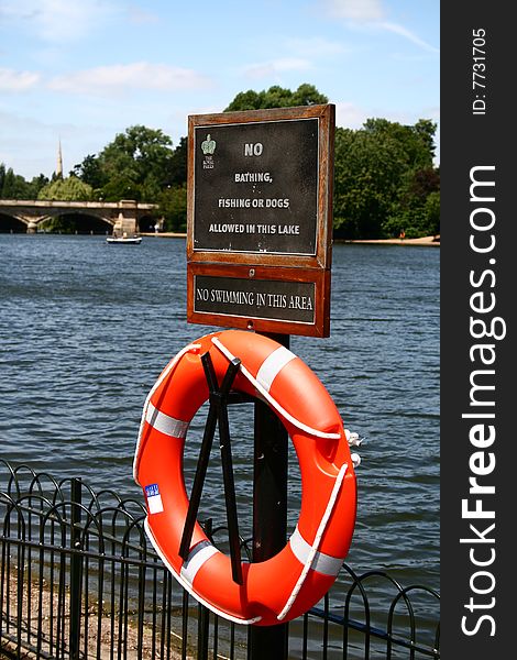 The life preserver hanging on the lake shore.