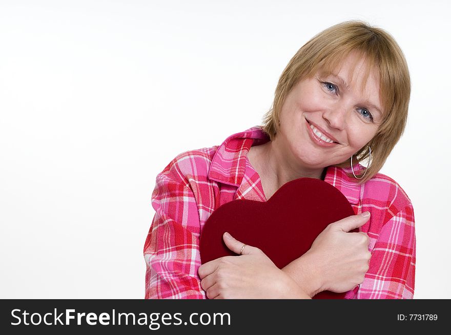 An attractive woman hugs the box of valentines day chocolates she just received as a gift. She is expression happiness. An attractive woman hugs the box of valentines day chocolates she just received as a gift. She is expression happiness.