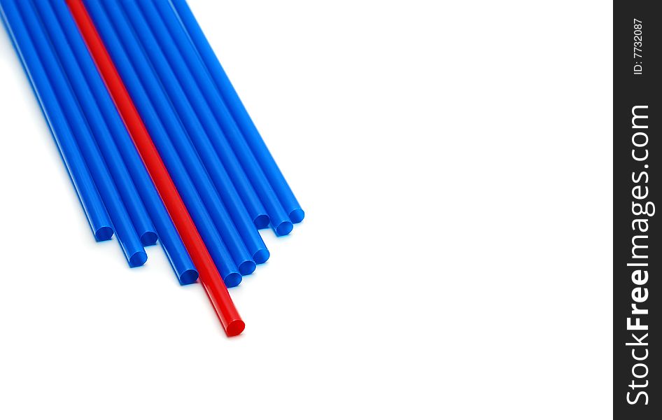 Single red straw between many blue straws. Single red straw between many blue straws