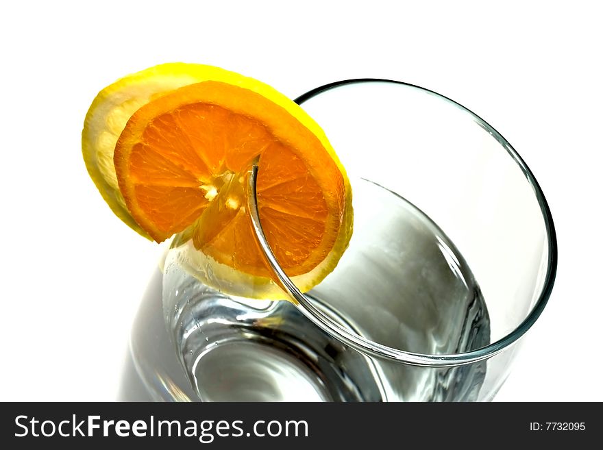 Fresh water with glass, lemon and orange decorated whit a circle. Isolated on white background. Fresh water with glass, lemon and orange decorated whit a circle. Isolated on white background.