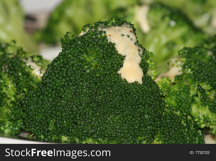 Cooked broccoli with a sauce on top