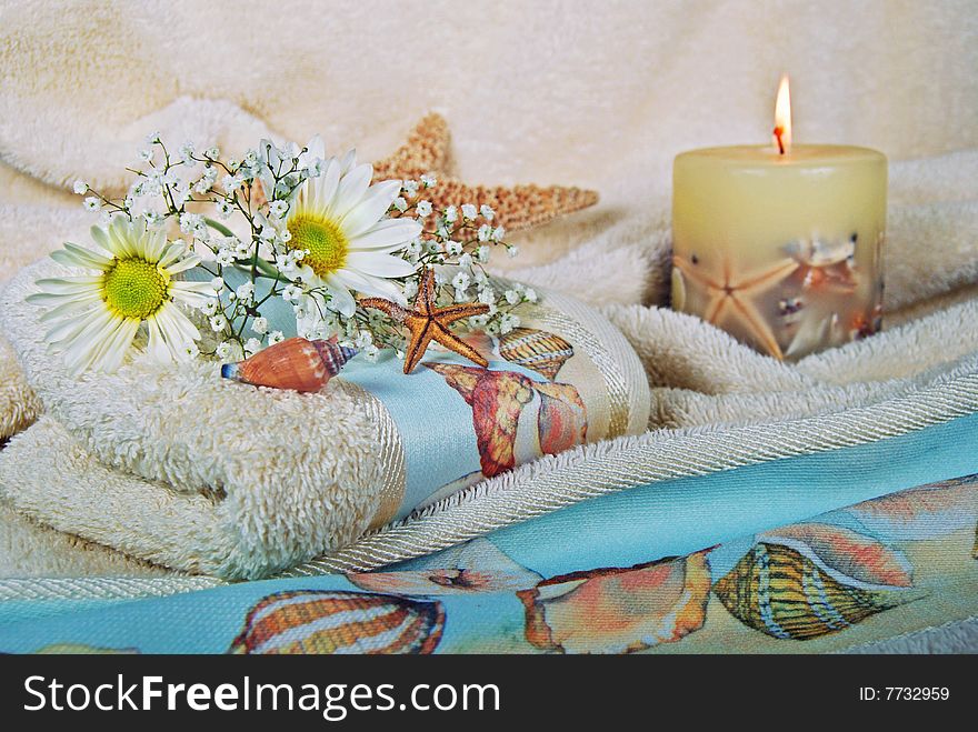 Stafish, daisies and candle on fluffy towels. Stafish, daisies and candle on fluffy towels.