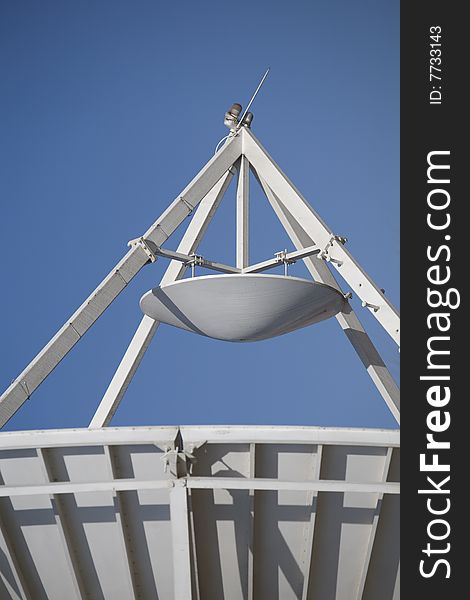 A large satellite dish by parabolic antenna on blue sky