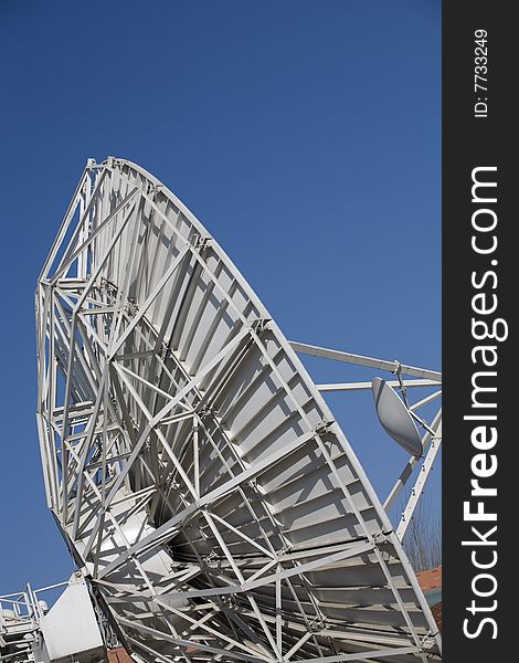 A large satellite dishes on blue sky