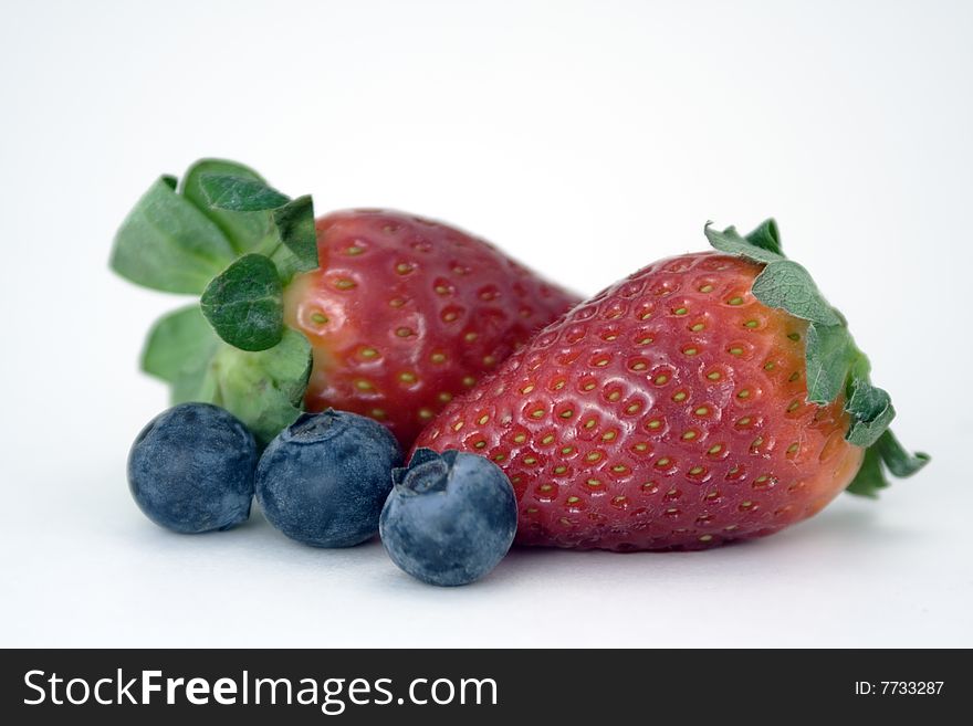 Two juicy strawberries, and three plump blueberries. Two juicy strawberries, and three plump blueberries