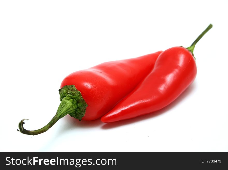 A red jalapeno pepper isolated on a white background. A red jalapeno pepper isolated on a white background.