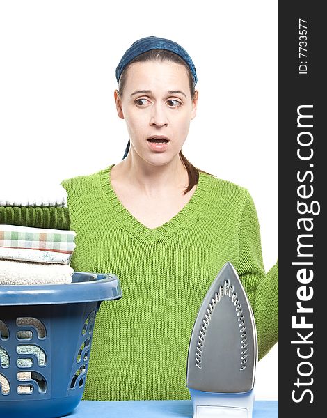 A woman in a domestic setting ready to tackle ironing on a white background. A woman in a domestic setting ready to tackle ironing on a white background