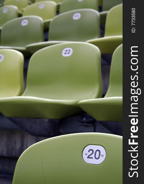 Lime-green stadium seats, number twenty. Lime-green stadium seats, number twenty