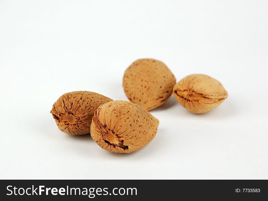 Four almond nuts on a white background. Four almond nuts on a white background