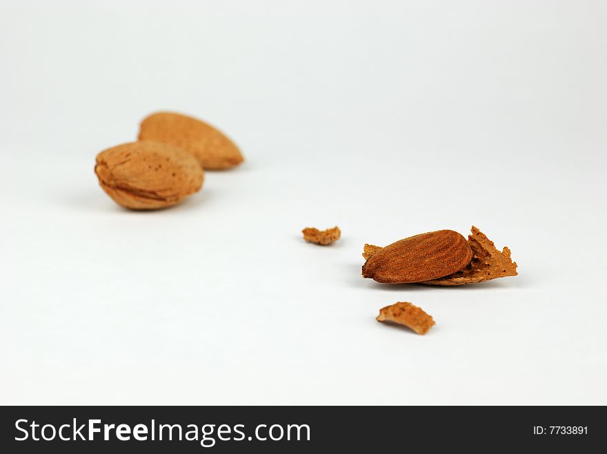 Three almond nuts on a white background. Three almond nuts on a white background