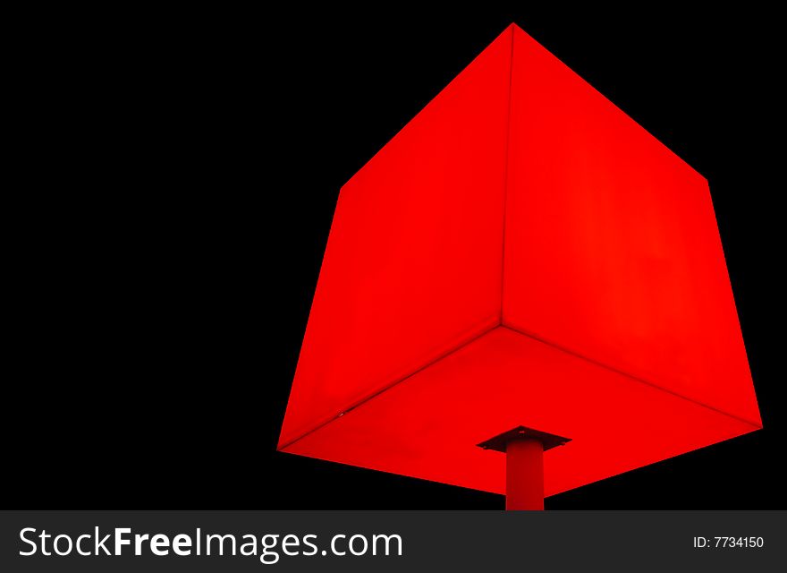 Illustration of red cube on leg at black background