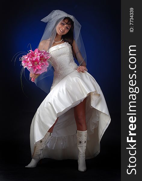 Young bride with bouquet of lilys show her legs