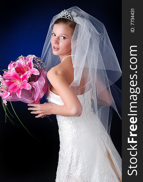 Young bride with bouquet of lilys on a black background