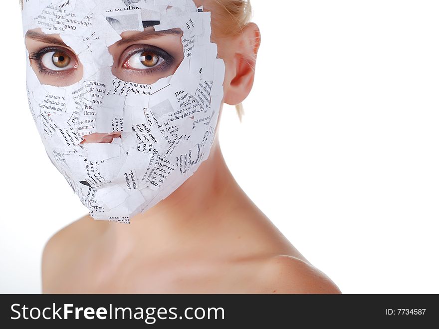 Face of a young woman in paper mask