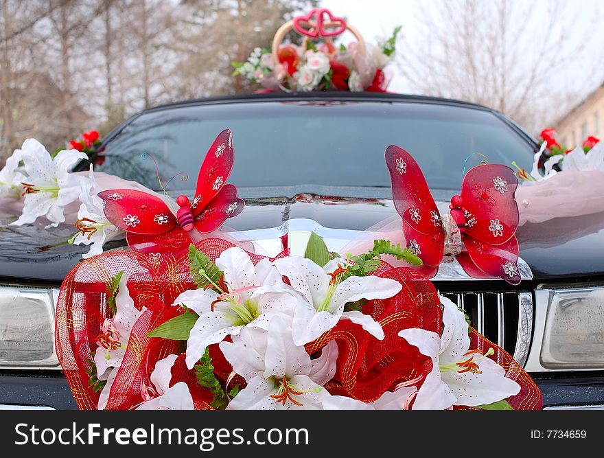 Wedding decoration on black limousine car.