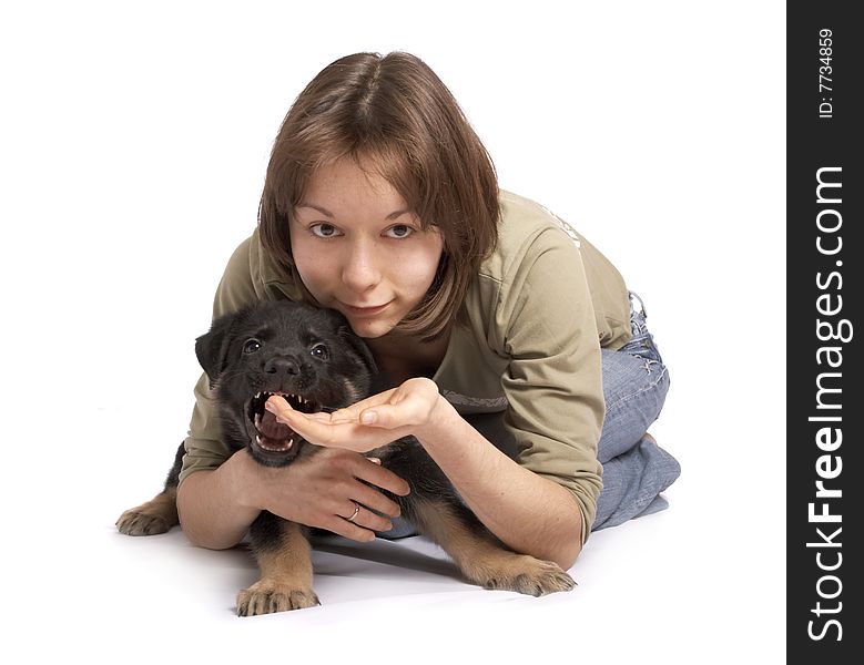 The girl holds the puppy in hands