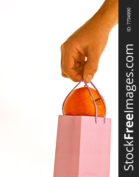 A red apple in a lunchbag on white background