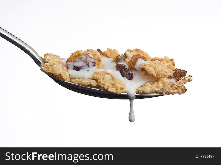 Bowl of cereal with raisins and milk isolated