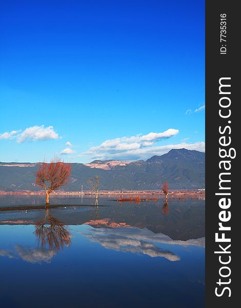 The picture was taken in Lashi Lake, Yunnan. The view in real world all reflect in the lake. Everything seems quiet and peaceful. The picture was taken in Lashi Lake, Yunnan. The view in real world all reflect in the lake. Everything seems quiet and peaceful.