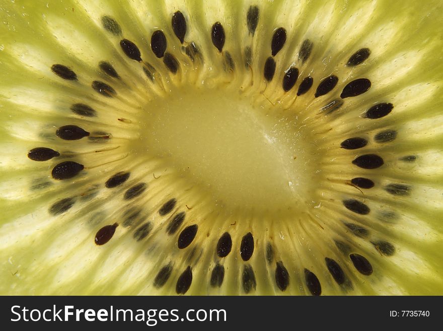 Sliced kiwi and look transparent and see small black seed texture. Sliced kiwi and look transparent and see small black seed texture.