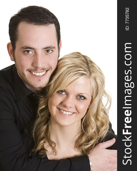 Attractive couple wearing black shirts against a white background. Attractive couple wearing black shirts against a white background.