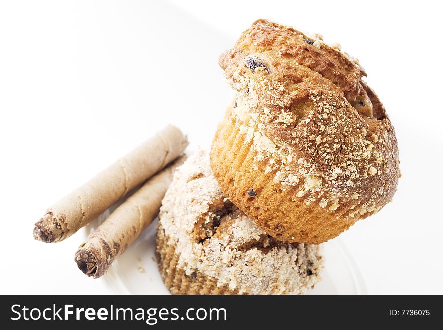 Two muffins one over another on white background