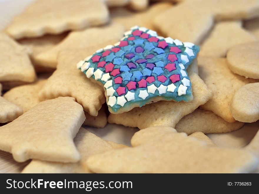 Decorated sugar cookie on plate of sugar cookies. Decorated sugar cookie on plate of sugar cookies