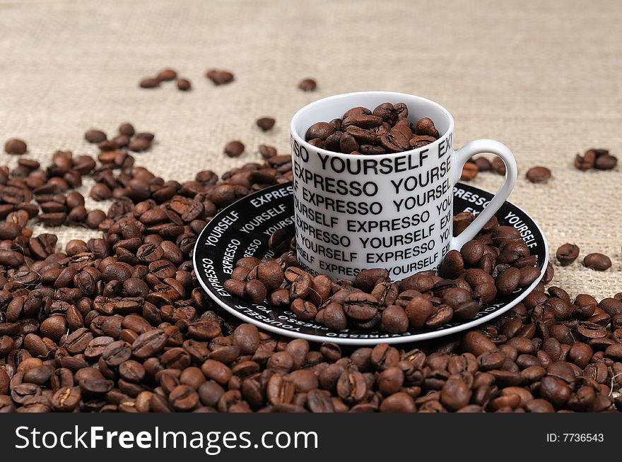 Coffee Beans and coffee cup on burlap