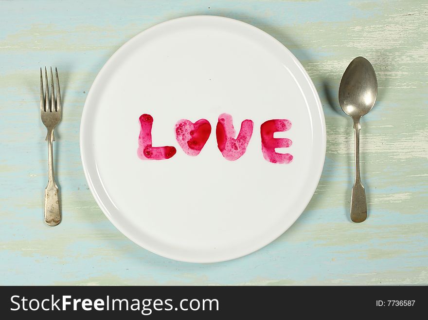 Red color of beet root is written on a plate as love, like ready to eat. Red color of beet root is written on a plate as love, like ready to eat.