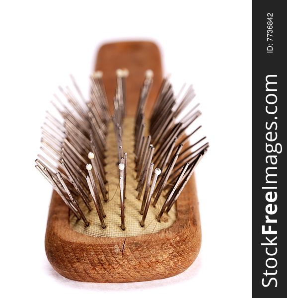 Old comb with wooden handle isolated on the white background. Used and dusty. Narrow depth of field. Old comb with wooden handle isolated on the white background. Used and dusty. Narrow depth of field.